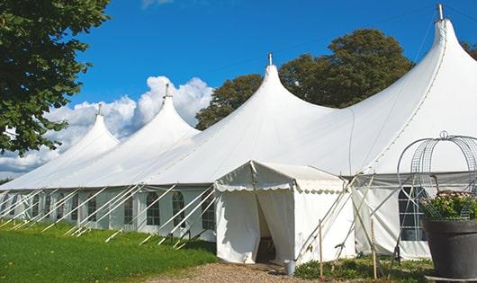 tall green portable restrooms assembled at a music festival, contributing to an organized and sanitary environment for guests in Diamond Bar